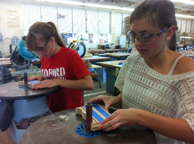 Drafting Tech student Rihanna Watson and Early Childhood student Carlee Watson work on sanding the sides of jewelry boxes. As part of the CTE scholarship application, students need to participate in a minimum of six hours making products for the fundraiser. 