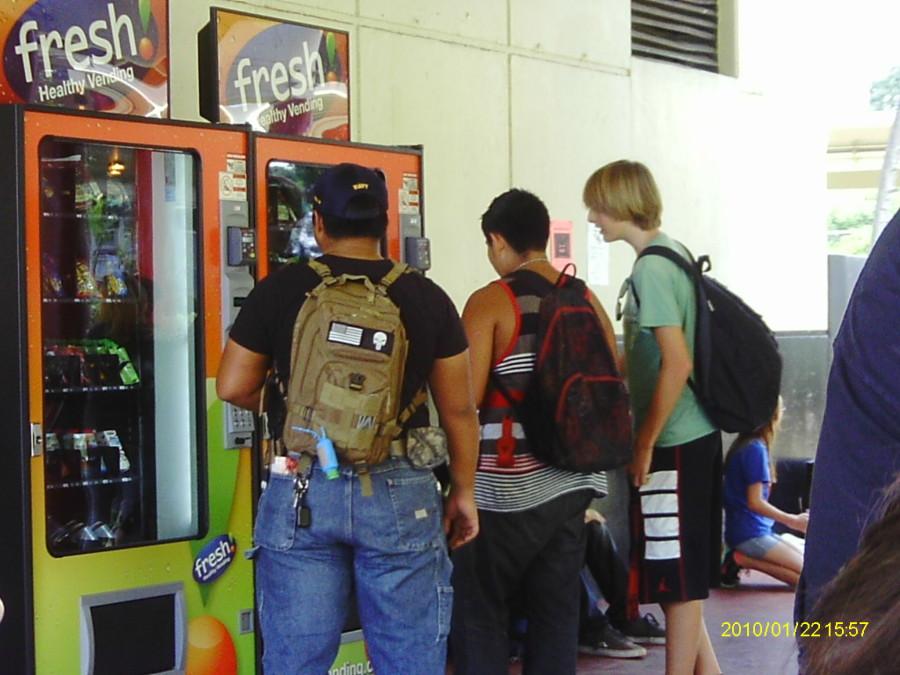 Customers crowd around two of three new vending machines, eager to purchase snacks. It’s the school’s first pair of healthy vending machines, introduced at the beginning of the 2014 school year to promote healthy snacks. “...I think it’s good they added them,” said Kim Nguyen (9).