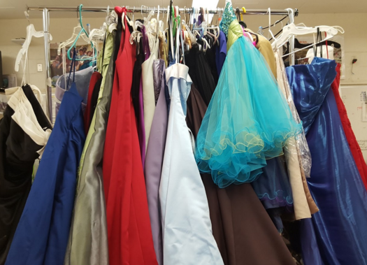 Racks of prom dresses and mens jackets are available to prom goers in room 113 . Attire and accessories are free of charge to students who are unable to pay the costs of prom wear. “Many alumni outgrow the dresses, or will never go to a prom again, or will get another gown,” Student Activities Coordinator John Goto said, “so there are always others who can use it to save their money for other things.” 