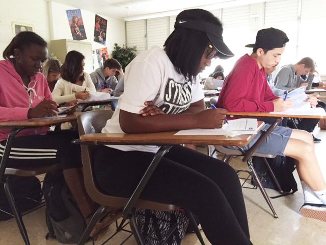 Advanced Placement students Brigina Terry (12), Zakiyah Stowe (12), and Jacob Nino (12) take an exam in their AP Language class. I spend about two and a half hours every night to study, Terry said. It really helps with strengthening my writing skills.