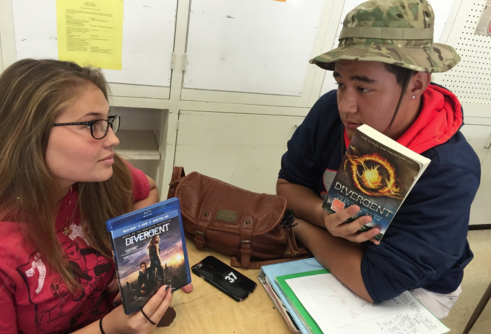 Keely Beck (12) and Alex Gibson (11) debate on the issue of books and movies. Many see movies as a better representation of a story, while others prefer to create their own story with books. “I’d rather watch the movie, it’s more interesting,” Beck said. (Photo by Adaliah Collins)