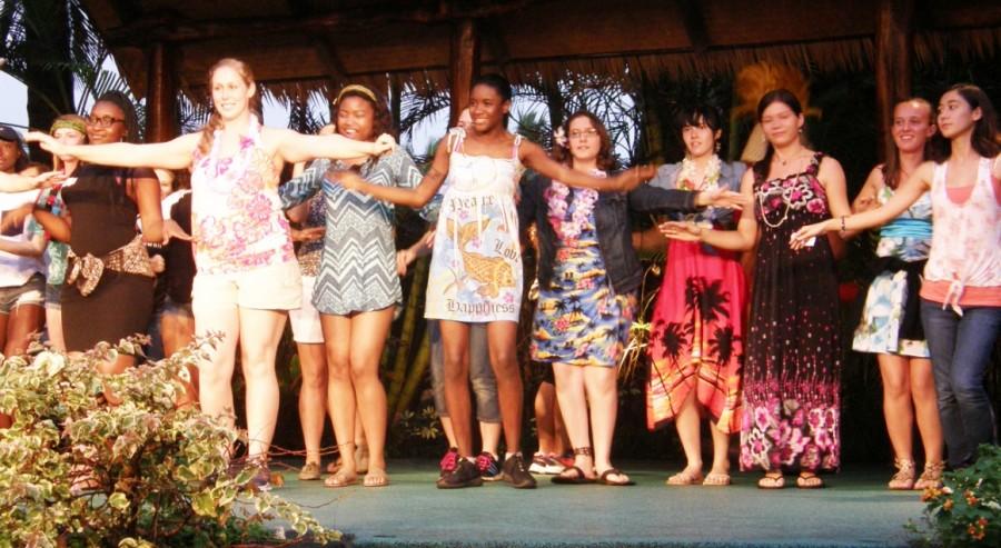 Class of 2016 advisor Christine Christe dances with members of the senior class at the Senior Luau held at the Polynesian Cultural Center. 