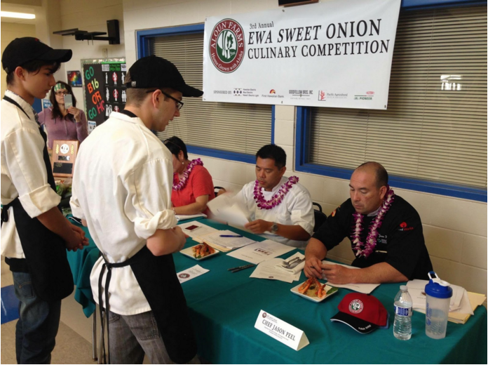 Culinary students Evan Collins (11) and Jeremiah Joswick (11) at the Aloun Farms 3rd Annual Ewa Sweet Onion Culinary Competition. The objective of the competition is to cook a dish with the items assigned to your team. “It was a good learning experience,” Joswick said. (Photo submitted by Evan Collins)