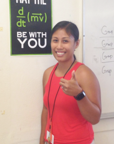 Conceptual Physics and Biology teacher Brittney Basilio poses next to a Physics poster, which is understood by those who know the equation for force. She is a long-time resident of the
