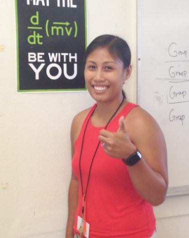 Conceptual Physics and Biology teacher Brittney Basilio poses next to a Physics poster, which is understood by those who know the equation for force. She is a long-time resident of the 