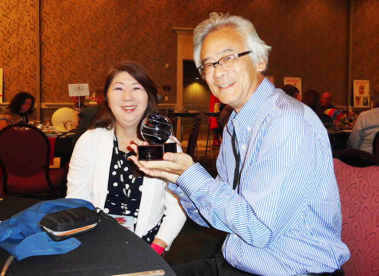 Graphics Communications teacher Lane Yokoyama, accompanied by his wife Loree, traveled to Vancouver, WA for the PrintRocks awards ceremony. Yokoyama was surprised with a special presentation at the ceremony, when he was awarded with a trophy and the Printastic Educator award.