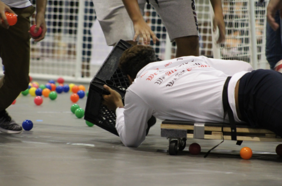 Justin Coronado (11), said “[Hungry, Hungry Hippos] consisted of 5 teams freshmen, sophomores, juniors, seniors, and teachers each trying to put as many balls as possible into a basket. One person from each team was tied down to a chair and another teammate had to pull them in and out to retrieve the balls. Whoever got the most balls in the basket won.
Matai Suitonu, another student who played, said The game they had me play was definitely tiring. It was a lot of fun and it felt good competing against the other classes and gettin the dubs.” Photo by Elaina Bolanos