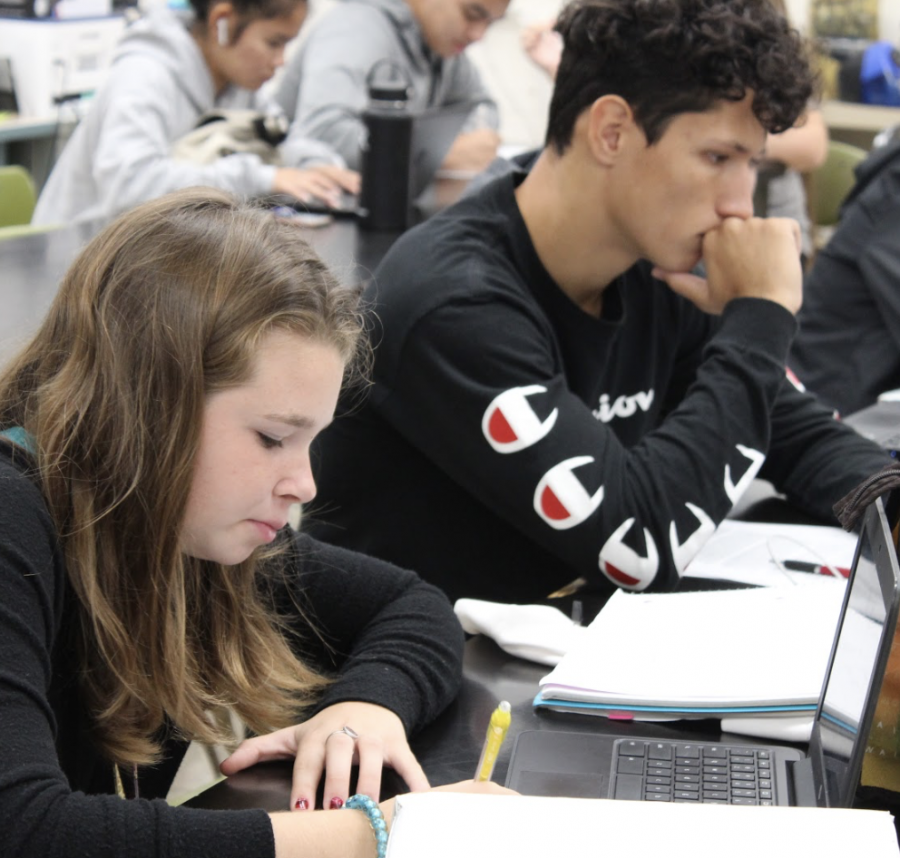 Seniors Samantha Simmons and Matai Suitonu use time in class to study. Simmons is reviewing for her Chemistry exam while Suitonu is working on his English assignment. “I don’t experience senioritis because I know I want to get into college and I need to keep my grades up for sports,” Simmons said. Photo by Elaina Bolanos