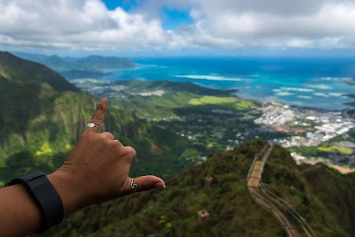 (photo taken by Daniella Griffay)  Daniella Griffay poses with a shaka at the top of the Stairway to Heaven overlooking Aiea Bay.  “I love hiking and the view is stunning and beautiful,” Griffay said.
