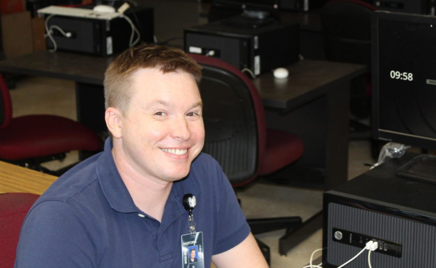 Nathan Krahn sits at one of the computers in his classroom. Krahn is the teacher of the new Cybersecurity 1 class. (Photo Credit: Andrew Luff)