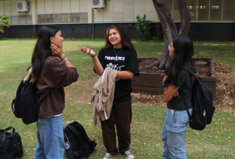 Freshman Sophia Tucker talks to her friends by the 10s Building. After two years of masked conversations students can now see each other’s faces. (Photo Credit: Grace Vuycankiat)