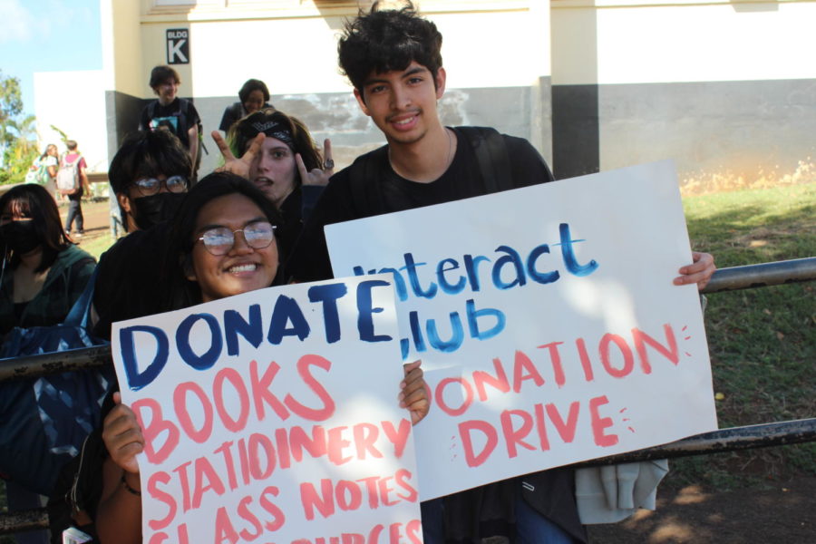Interact Club members Jayde-Emaree Ramos and Benjamin Sanchez-Romero collect donations in the student parking lot after school.