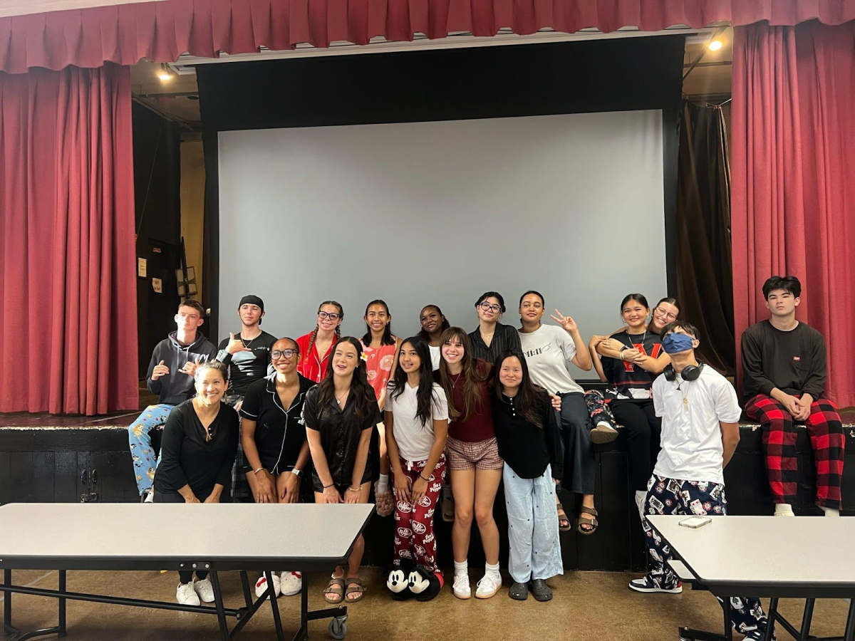 Calin Robertson, Jaxon Turner, Lyla Matthews, Brayden Ng, Gabrielle Betts, Erica Armstrong, Mikala Barrett, Kiana Watts, Carly Reed, Jennifer Nguyen, Lindsey Coates, Aurianna Perreira Bolosan, Gwen Villarin, Shanntay Stroman, Lucas Brady, and Mrs. Arisumi taking a group photo at the stage during the event.