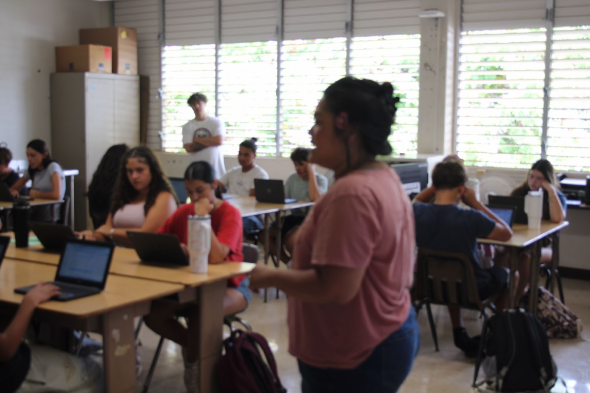 Mrs. Foumai explains a class assignment to her World History students.