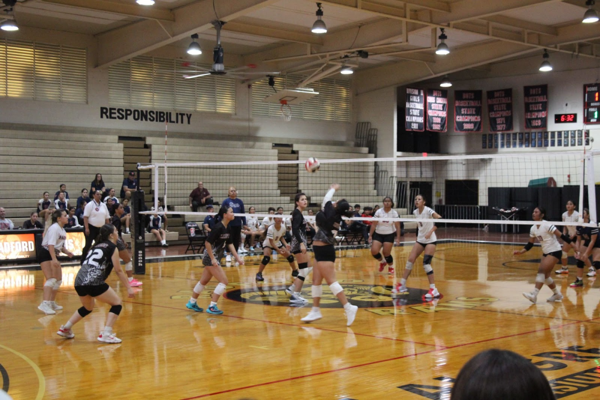 Madelyn Babb, Alana Meaders, Arshalyn Agmata, Keileana Tiqui, Ahnyx Barrett, A'Nylah Hughes in action on the volleyball court.