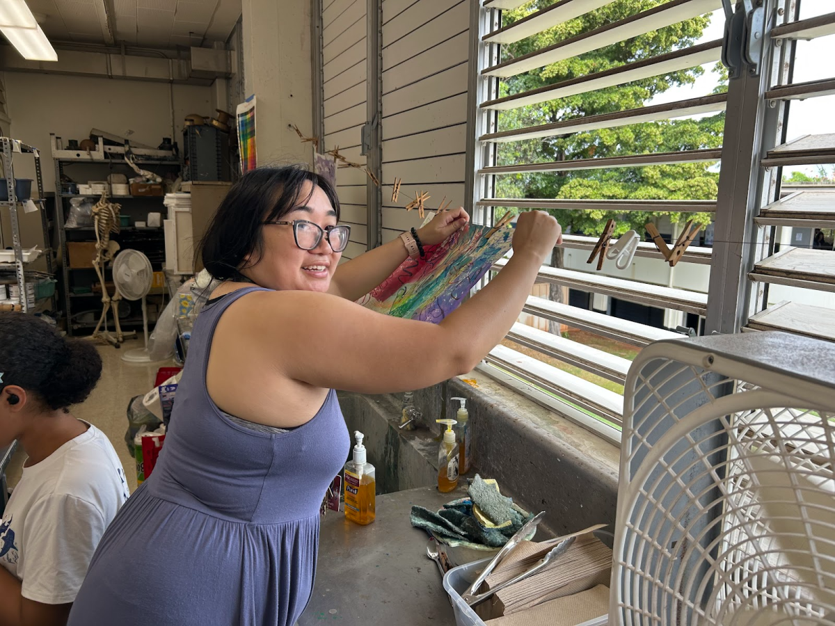 Ms. Auyong hanging up a student’s artwork to dry. This is the Drawing/Painting 1 students’ first project of the year.